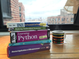 Stack of programming books and cup of tea